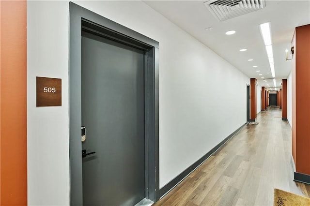 corridor featuring light hardwood / wood-style floors