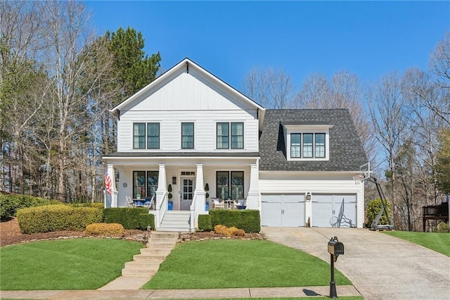 traditional home featuring board and batten siding, a porch, concrete driveway, and a front yard