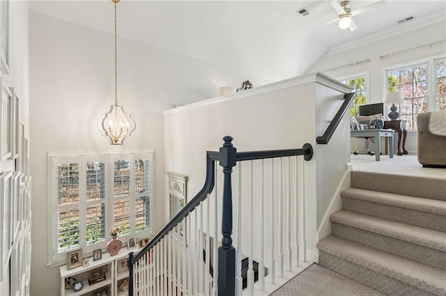 5807 Peacock Ln, Hoschton, GA 30548 - stairway featuring ceiling fan with notable chandelier, visible vents, and high vaulted ceiling
