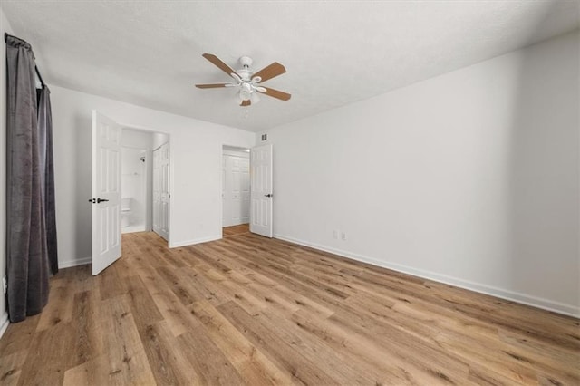 unfurnished bedroom with ceiling fan and light wood-type flooring