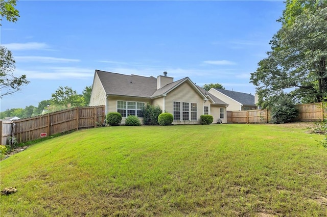 1530 Brisbane Dr, Dacula, GA 30019 - back of house with a fenced backyard and a chimney