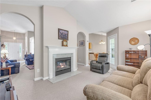 1530 Brisbane Dr, Dacula, GA 30019 - living room with carpet, arched walkways, a premium fireplace, healthy amount of natural light, and lofted ceiling