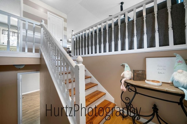 stairs with baseboards and wood finished floors