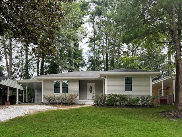 view of front of house with a carport and a front lawn