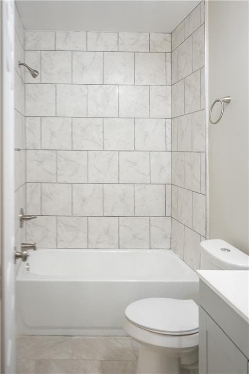 full bathroom featuring toilet, tile patterned floors, vanity, and tiled shower / bath