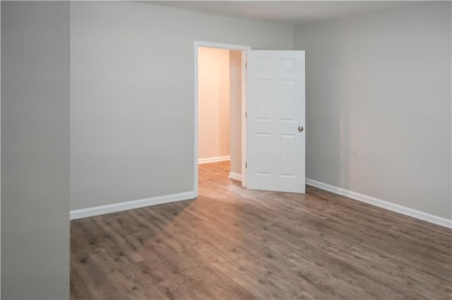 spare room with hardwood / wood-style floors