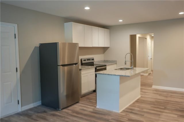 kitchen featuring light hardwood / wood-style flooring, sink, white cabinets, and stainless steel fridge