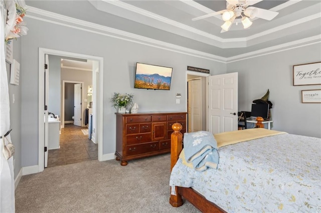 bedroom with baseboards, carpet flooring, ornamental molding, and a raised ceiling