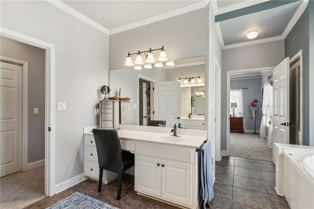 bathroom featuring vanity, a tub, baseboards, and crown molding