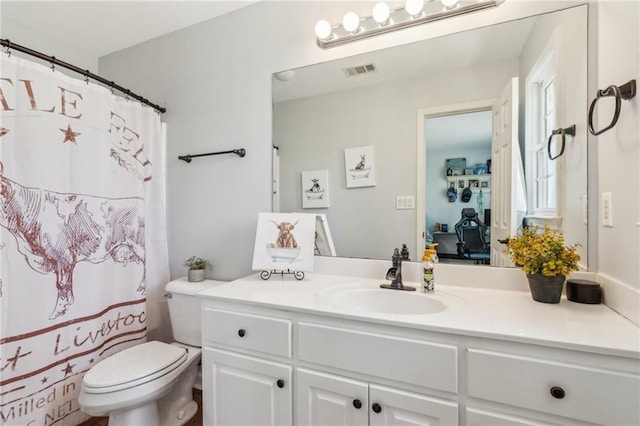 full bathroom with visible vents, toilet, and vanity