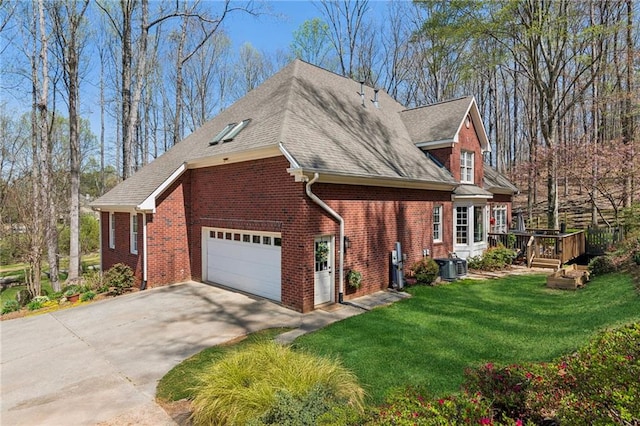 view of side of property featuring central air condition unit, a wooden deck, driveway, brick siding, and a yard