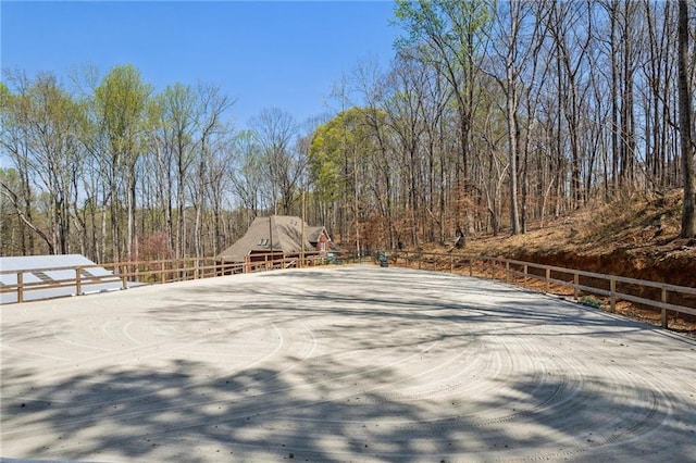 view of yard featuring fence and a forest view