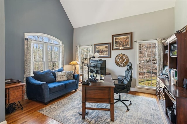 office with high vaulted ceiling and wood finished floors