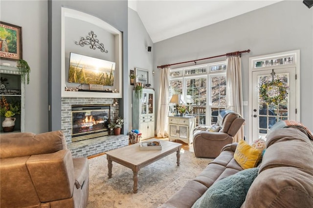 living room with a fireplace and high vaulted ceiling