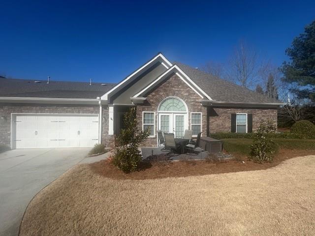 3311 Lindenridge Dr, Buford, GA 30519 - single story home featuring a garage, driveway, brick siding, and a shingled roof