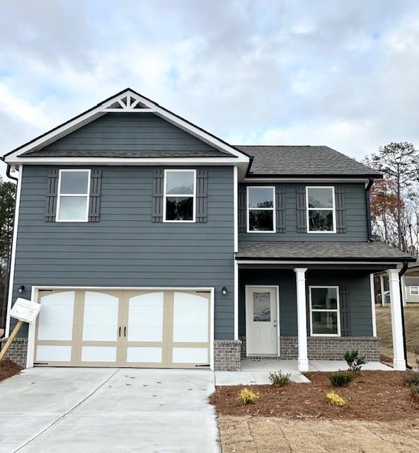 view of front facade featuring a garage and a porch