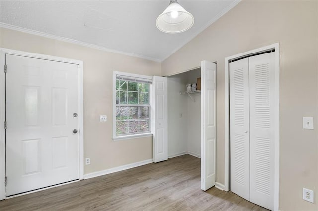 354 Henry Aaron Ave SW, Atlanta, GA 30310 - unfurnished bedroom with vaulted ceiling, crown molding, two closets, wood finished floors, and baseboards