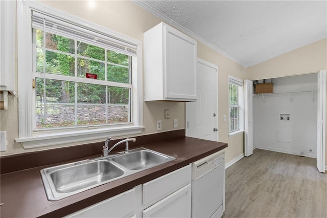 354 Henry Aaron Ave SW, Atlanta, GA 30310 - kitchen with white dishwasher, a sink, dark countertops, white cabinets, and ornamental molding
