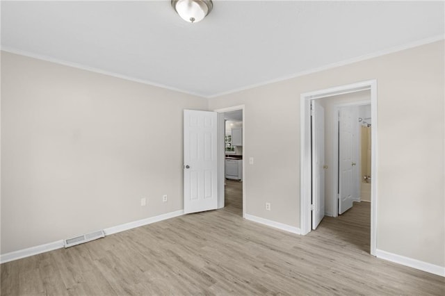 354 Henry Aaron Ave SW, Atlanta, GA 30310 - unfurnished bedroom featuring baseboards, light wood-style floors, and crown molding