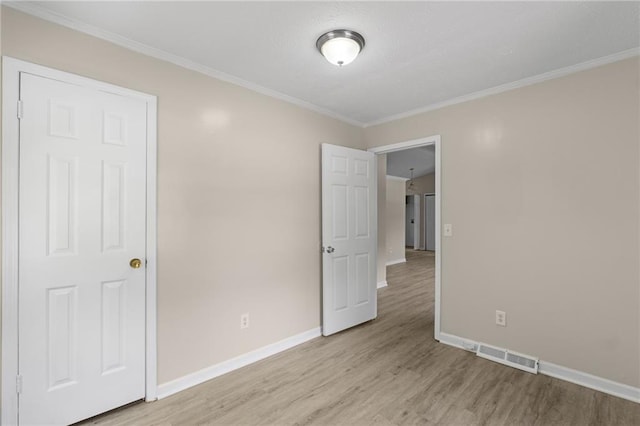 354 Henry Aaron Ave SW, Atlanta, GA 30310 - unfurnished bedroom with light wood-style flooring, baseboards, and ornamental molding