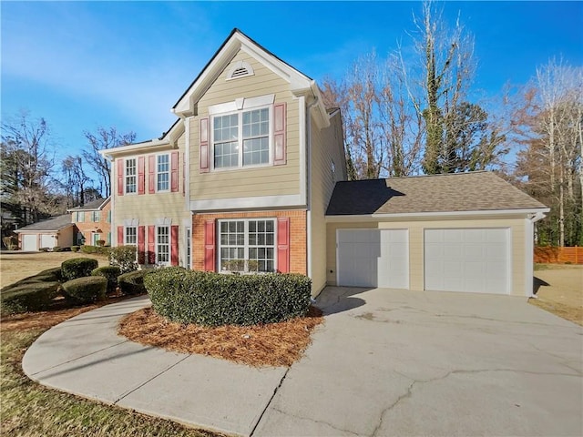 view of front of house featuring driveway, brick siding, and an attached garage