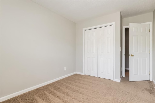 112 Hawkeye Ln, Conyers, GA 30012 - unfurnished bedroom with carpet flooring, baseboards, and a closet