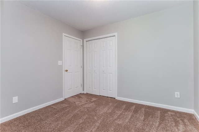 112 Hawkeye Ln, Conyers, GA 30012 - unfurnished bedroom featuring carpet, baseboards, and a closet