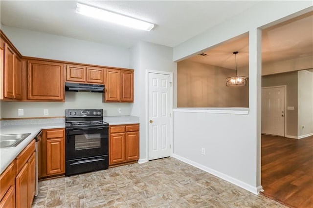 112 Hawkeye Ln, Conyers, GA 30012 - kitchen with black range with electric stovetop, under cabinet range hood, brown cabinetry, light countertops, and baseboards
