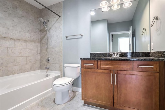 full bathroom featuring tile patterned flooring, toilet, vanity, and tiled shower / bath