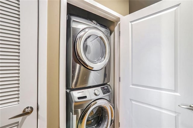 washroom featuring stacked washer and dryer