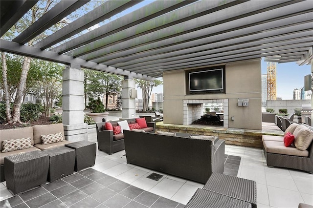 view of patio / terrace featuring an outdoor living space with a fireplace and a pergola