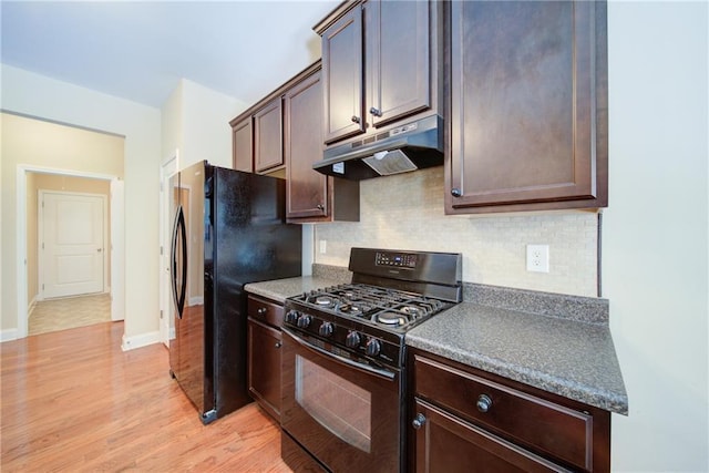 1575 Parkside Village Dr, Cumming, GA 30040 - kitchen with black appliances, under cabinet range hood, light wood-type flooring, backsplash, and dark brown cabinets
