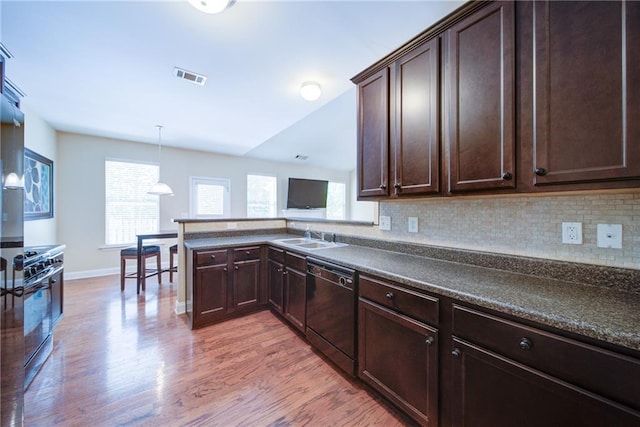 1575 Parkside Village Dr, Cumming, GA 30040 - kitchen featuring black dishwasher, a sink, light wood-type flooring, dark brown cabinetry, and dark countertops
