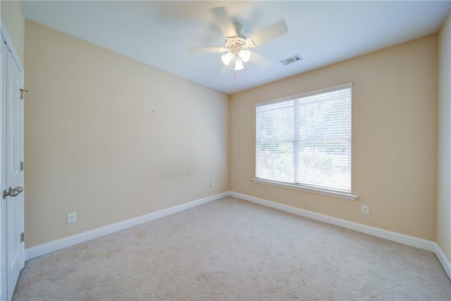 1575 Parkside Village Dr, Cumming, GA 30040 - spare room featuring light carpet, ceiling fan, and baseboards