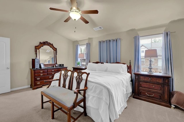 bedroom with light colored carpet, ceiling fan, baseboards, visible vents, and lofted ceiling