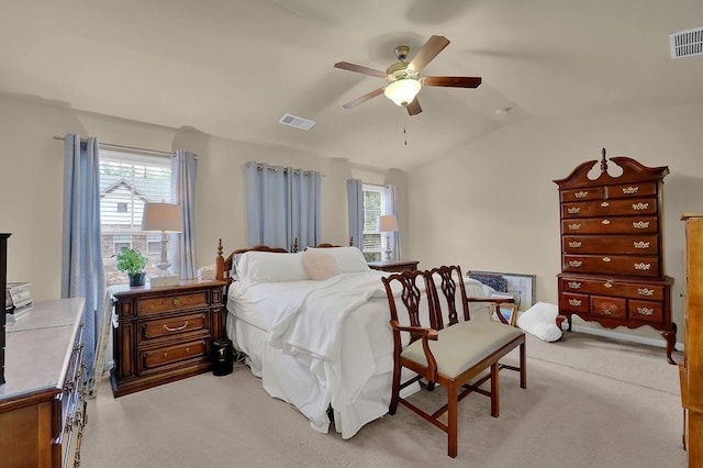 bedroom featuring visible vents, lofted ceiling, and light colored carpet