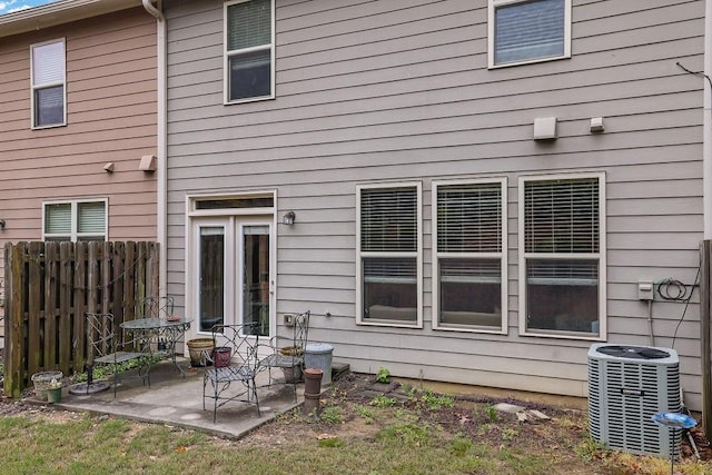 rear view of property with a patio, fence, and central AC unit