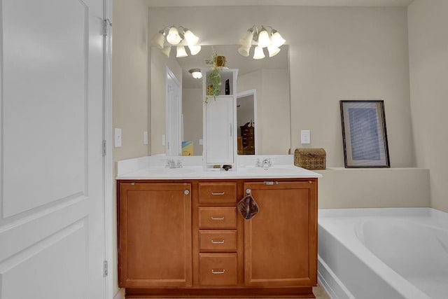 full bathroom featuring double vanity, a bath, and a sink