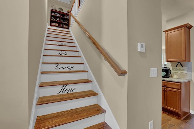 stairway featuring wood finished floors