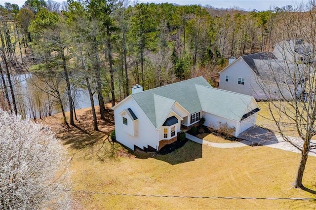 birds eye view of property with a wooded view