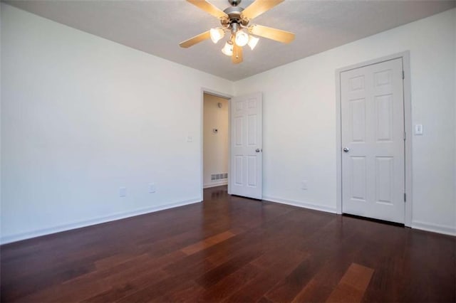 unfurnished bedroom with visible vents, ceiling fan, baseboards, and wood finished floors