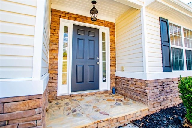 entrance to property with stone siding