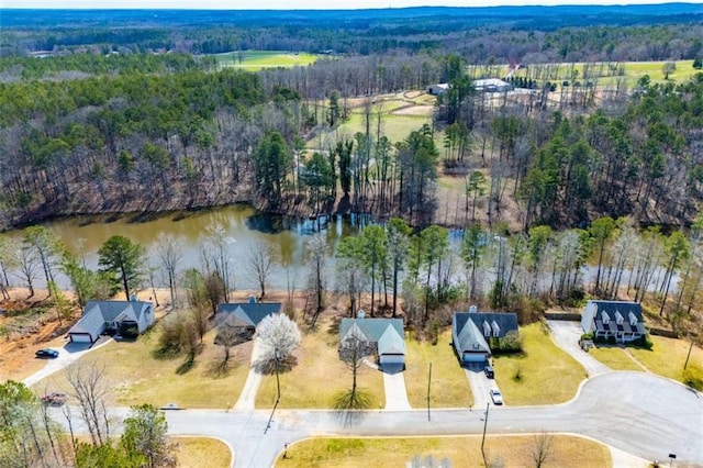 aerial view with a wooded view and a water view