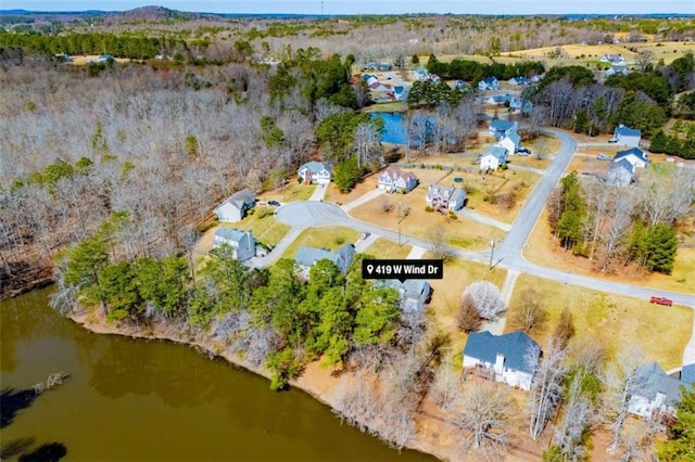 aerial view featuring a water view and a view of trees