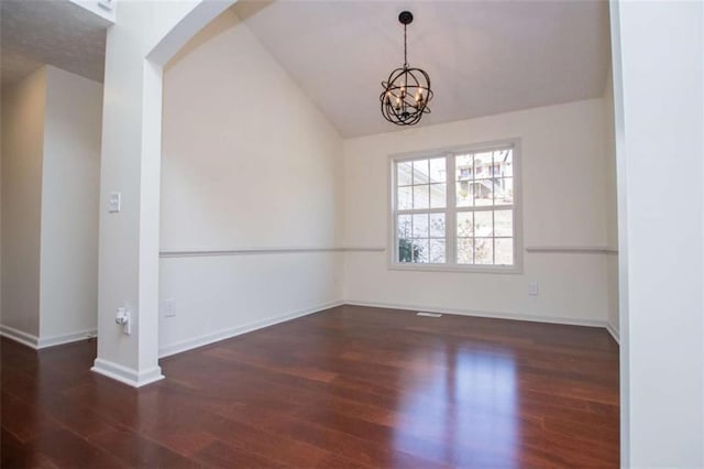 unfurnished room with a chandelier, baseboards, lofted ceiling, and wood finished floors