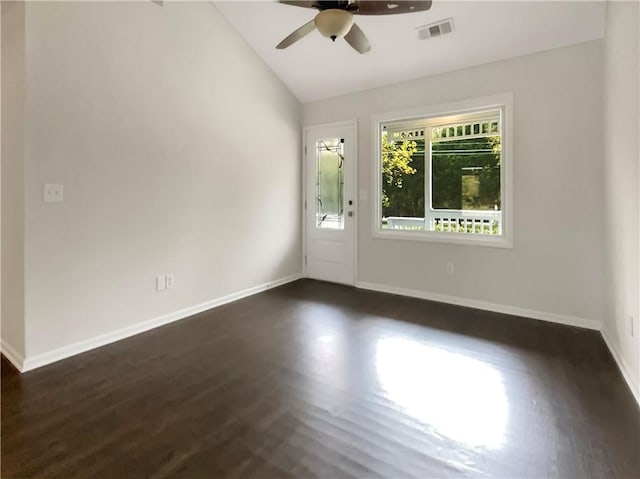 spare room featuring lofted ceiling, dark wood-type flooring, and ceiling fan