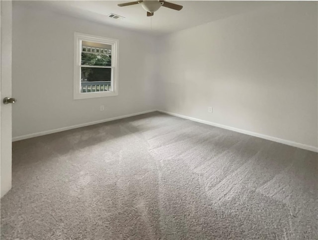 carpeted spare room with ceiling fan