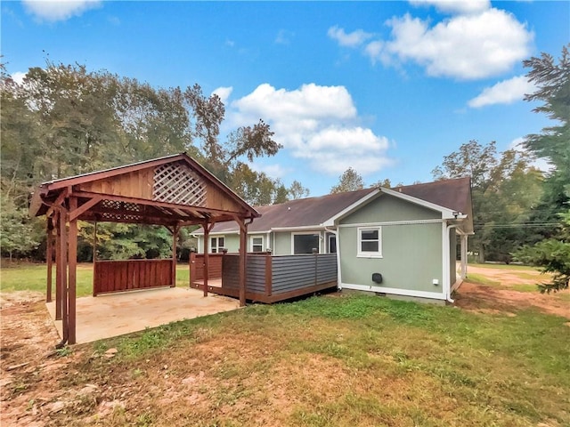 rear view of house with a patio, a gazebo, and a lawn