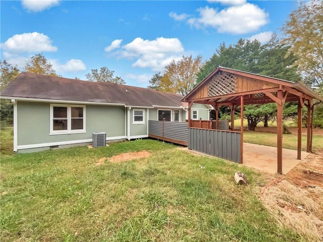 exterior space featuring a gazebo, a deck, a yard, and central AC unit