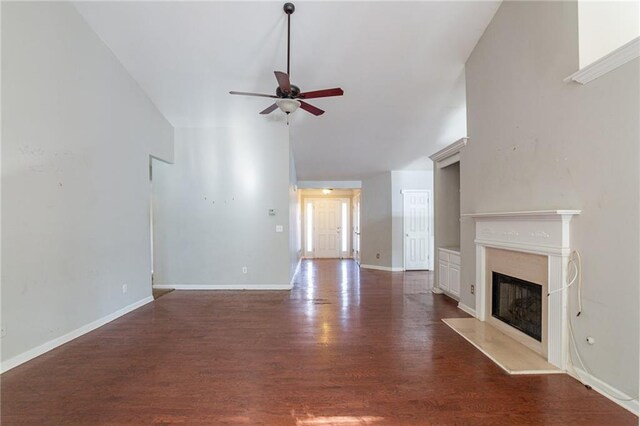 unfurnished living room featuring ceiling fan and dark hardwood / wood-style floors